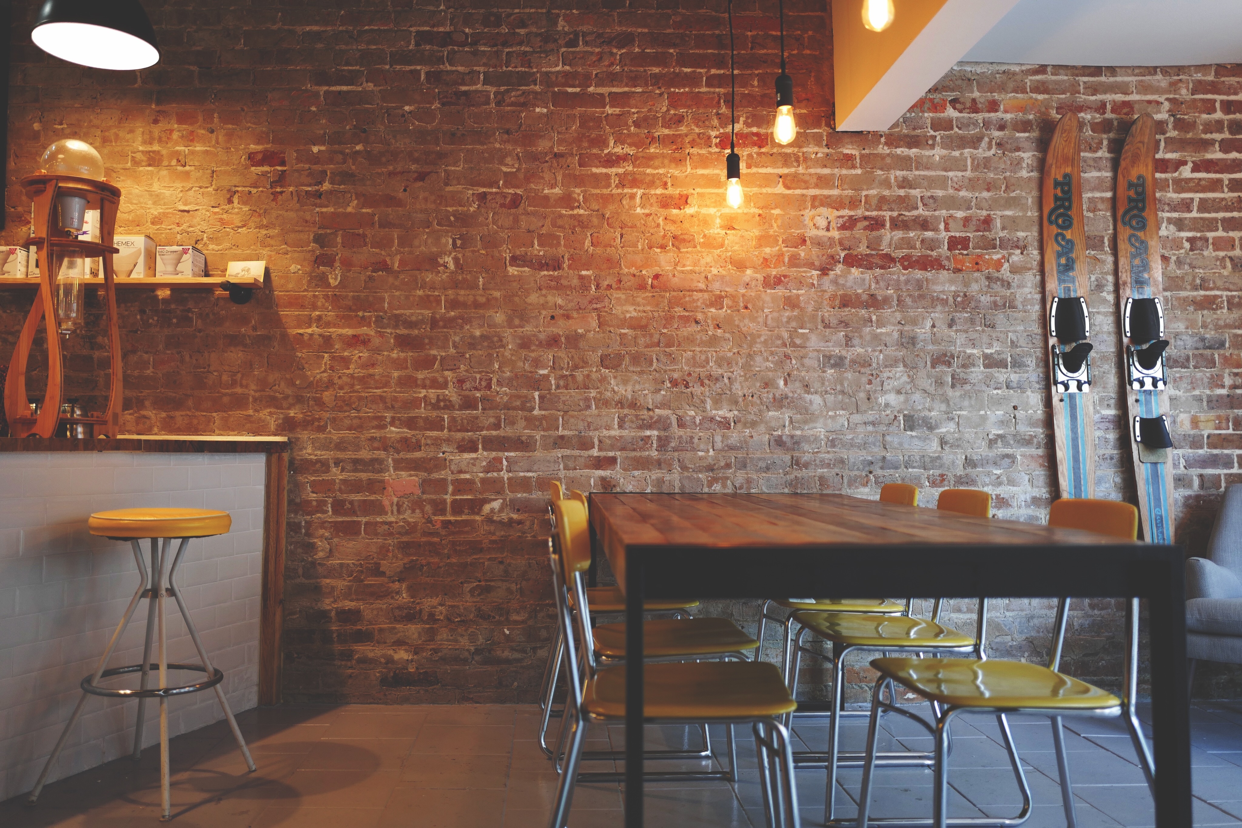Warm brick wall seating nook with Edison lights